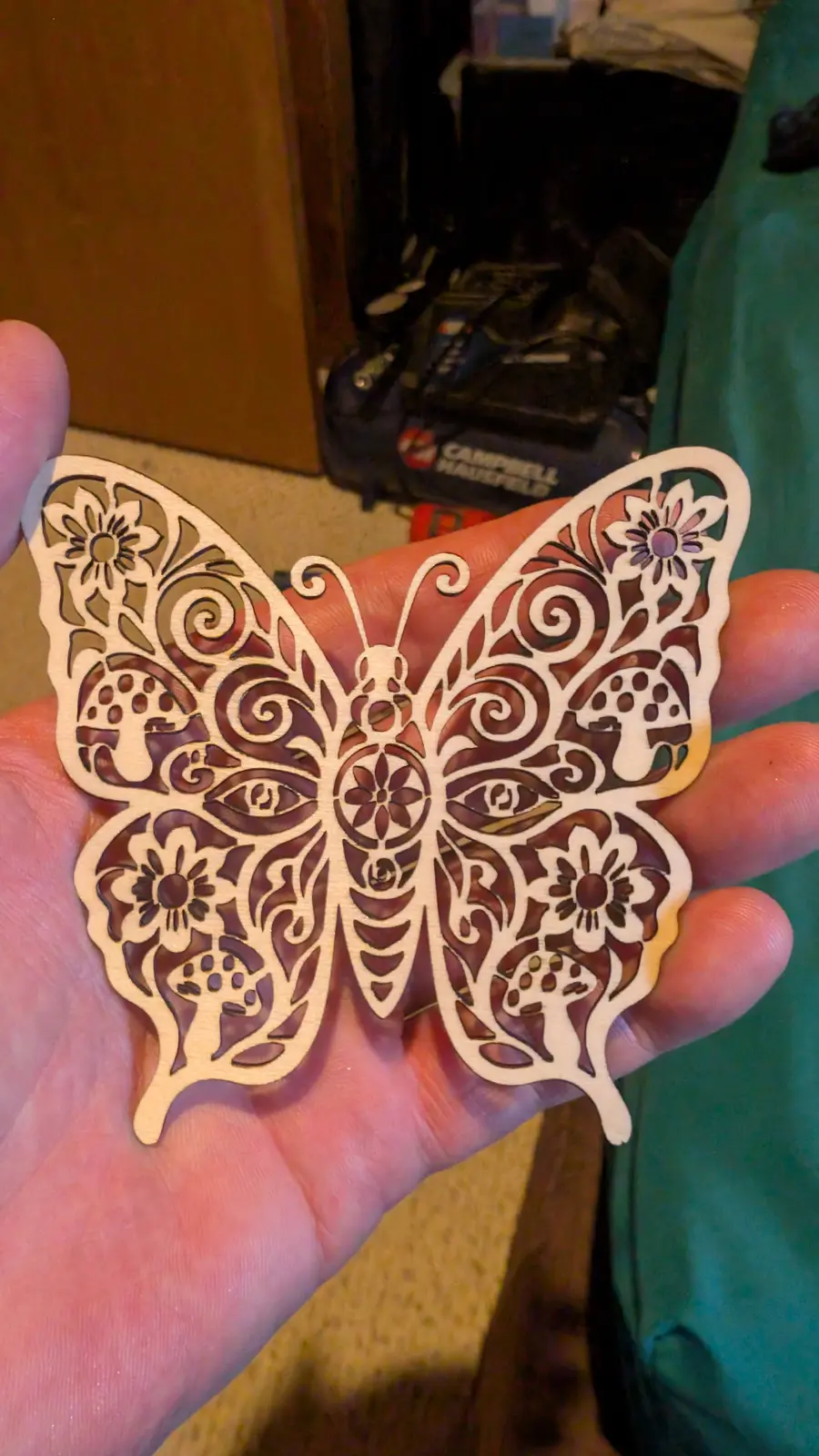 Intricate laser-cut butterfly with flowers, mushrooms and moth details